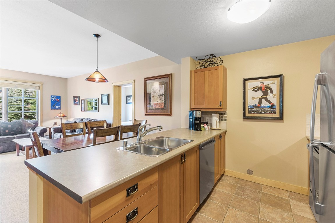 910 Copper Road, Unit 219 Copper Mountain, CO 80443 - Photo 11 of 33 a living room with stainless steel appliances kitchen island granite countertop a sink a counter top space and a view of living room