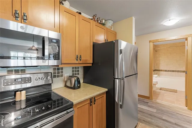 a kitchen with appliances and cabinets