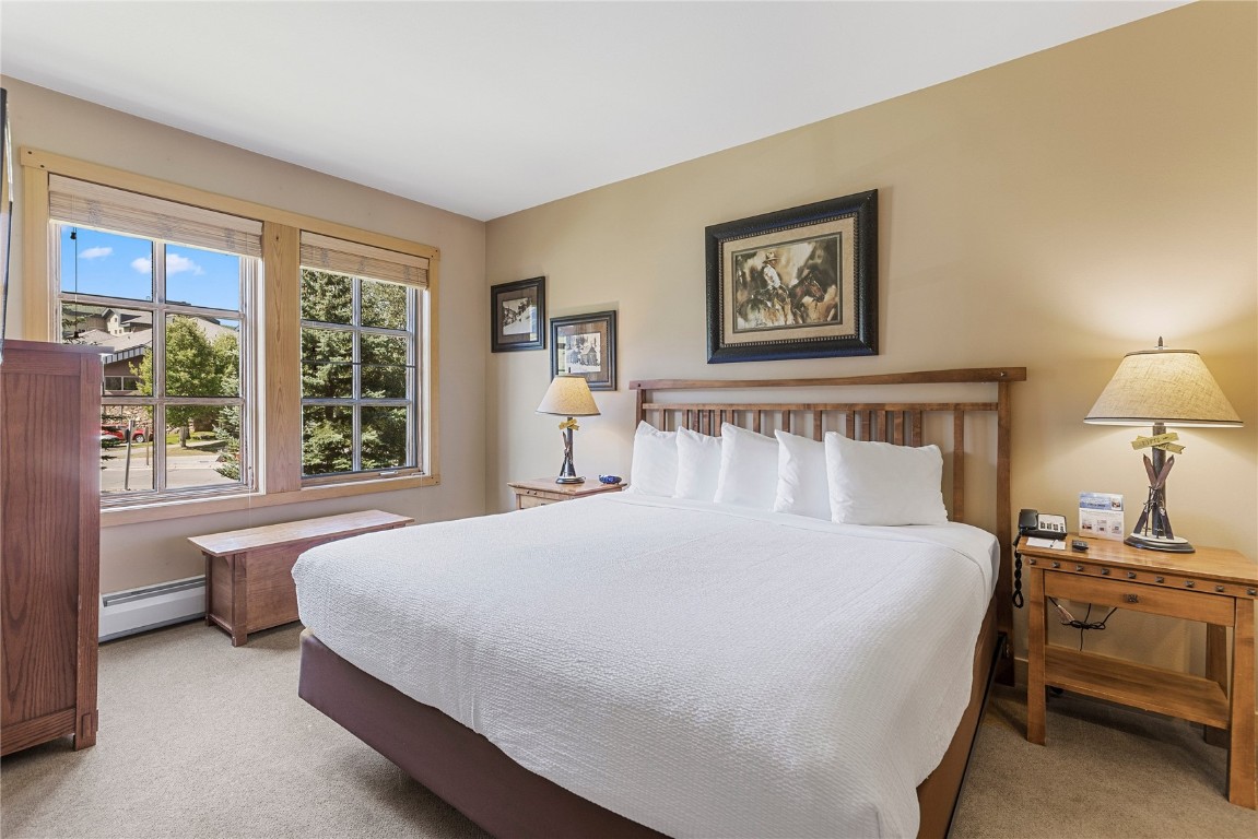 910 Copper Road, Unit 219 Copper Mountain, CO 80443 - Photo 14 of 33 a bedroom with a large bed and a window