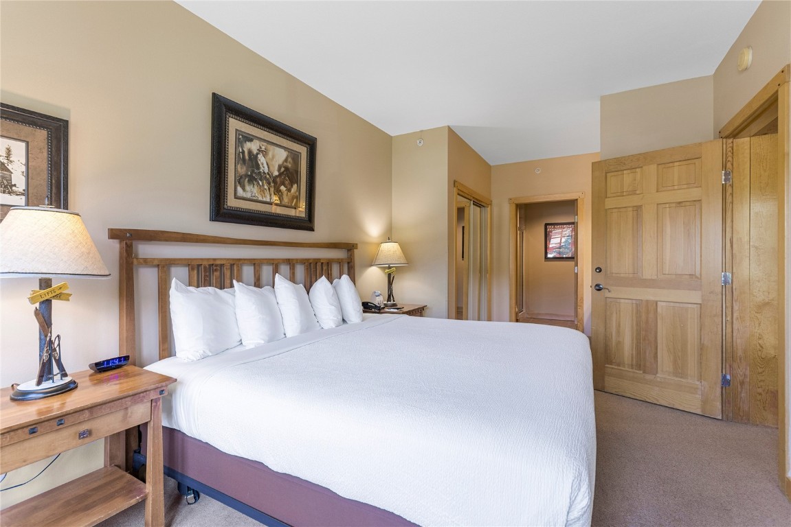 910 Copper Road, Unit 219 Copper Mountain, CO 80443 - Photo 15 of 33 a bedroom with a bed and a lamp on table