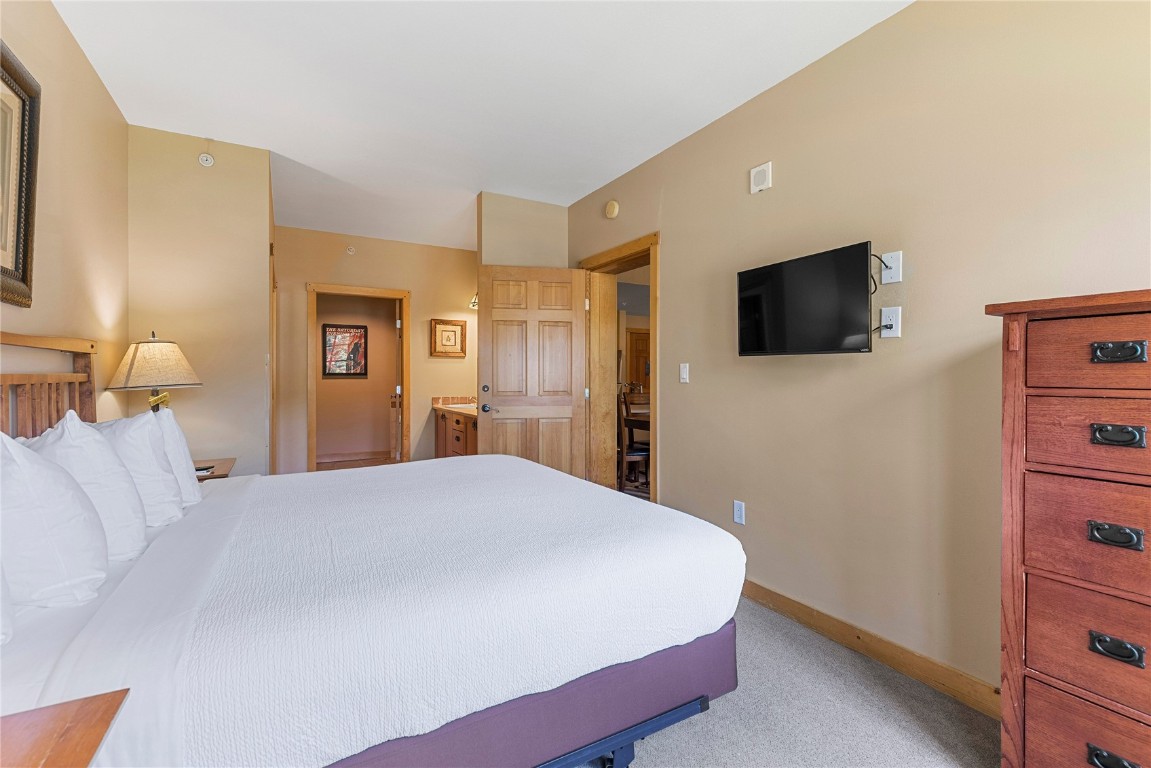910 Copper Road, Unit 219 Copper Mountain, CO 80443 - Photo 16 of 33 a bedroom with a bed and a flat screen tv