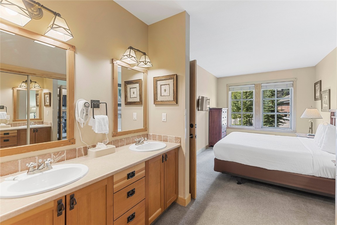 910 Copper Road, Unit 219 Copper Mountain, CO 80443 - Photo 17 of 33 a spacious bedroom with a bed and a sink