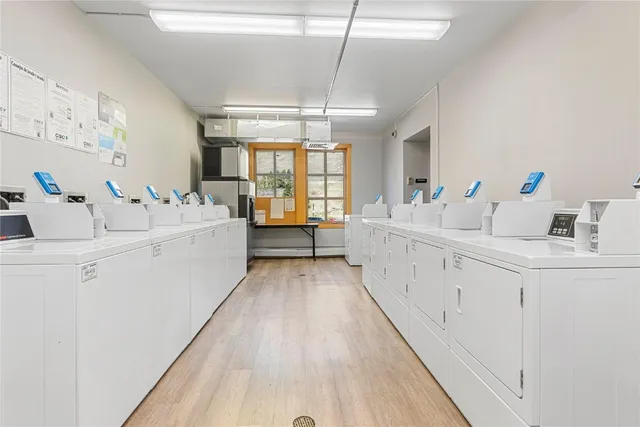 a large white room with mirror and sink