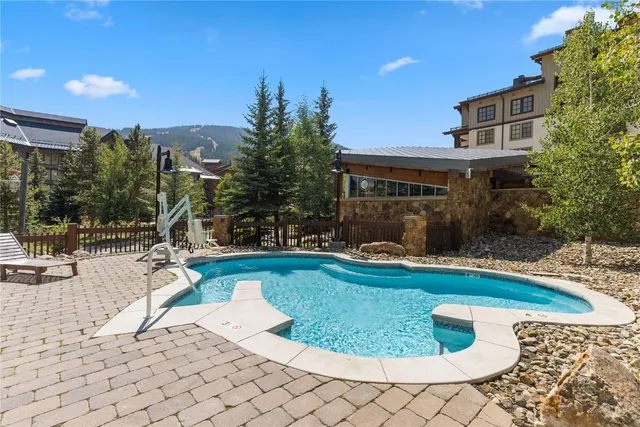 a view of a house with swimming pool and sitting area