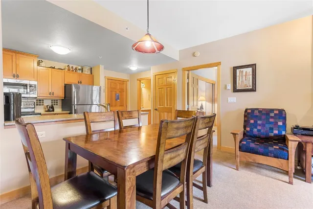 a dining room with furniture and wooden floor
