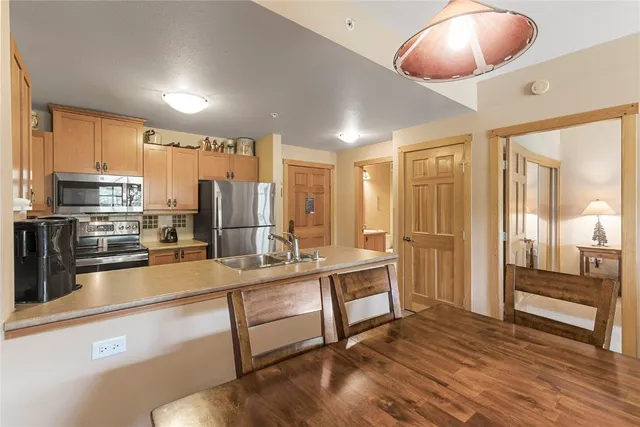 a large kitchen with a large window and stainless steel appliances