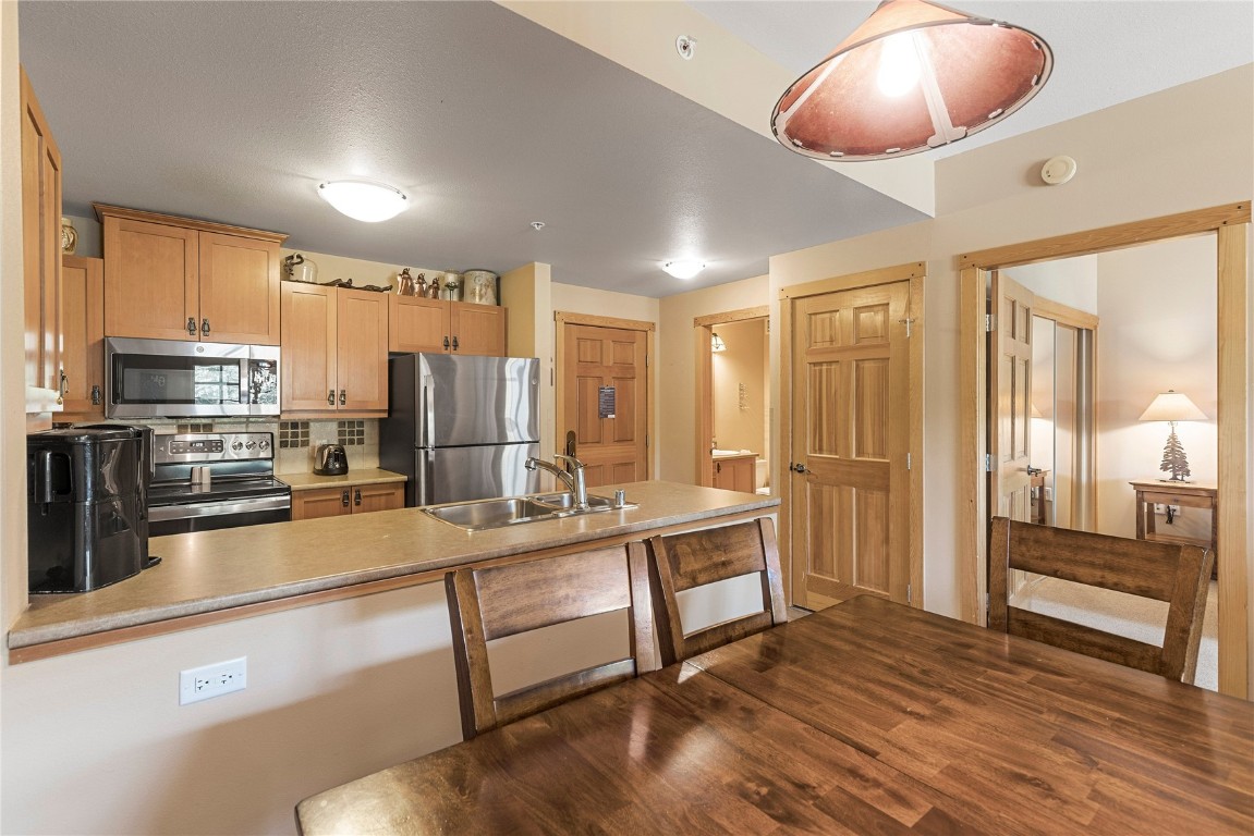 910 Copper Road, Unit 219 Copper Mountain, CO 80443 - Photo 10 of 33 a large kitchen with a large window and stainless steel appliances
