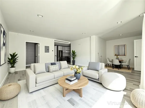 a living room with furniture a glass table and a large window