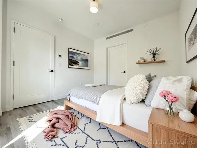 a bedroom with a bed and a painting on the wall