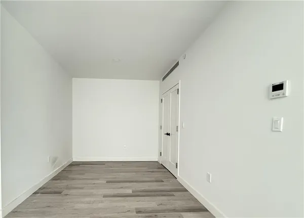 a view of hallway with wooden floor