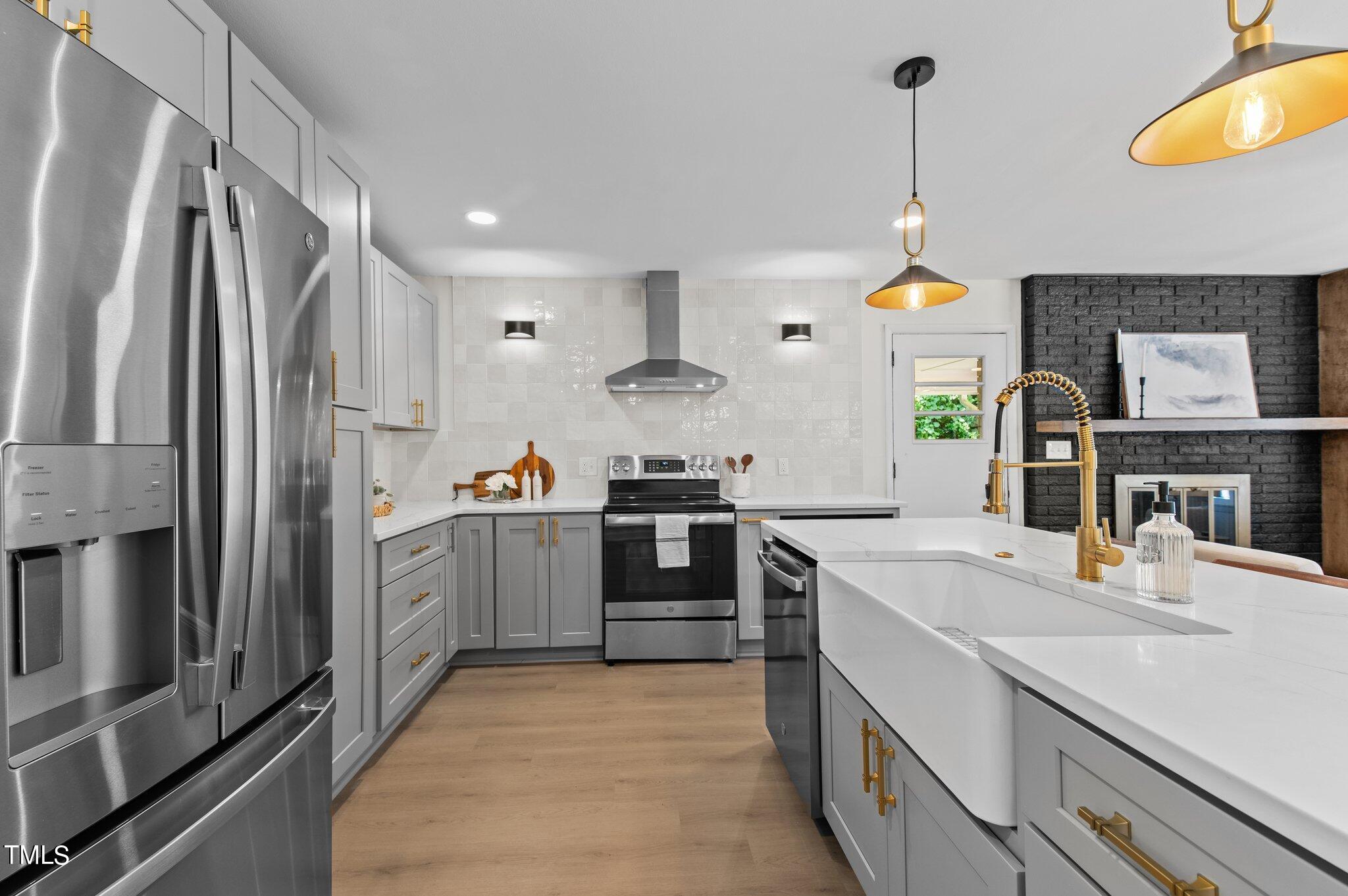 405 Roxanne Drive Raleigh, NC 27603 - Photo 13 of 48 a kitchen with a sink stainless steel appliances and cabinets