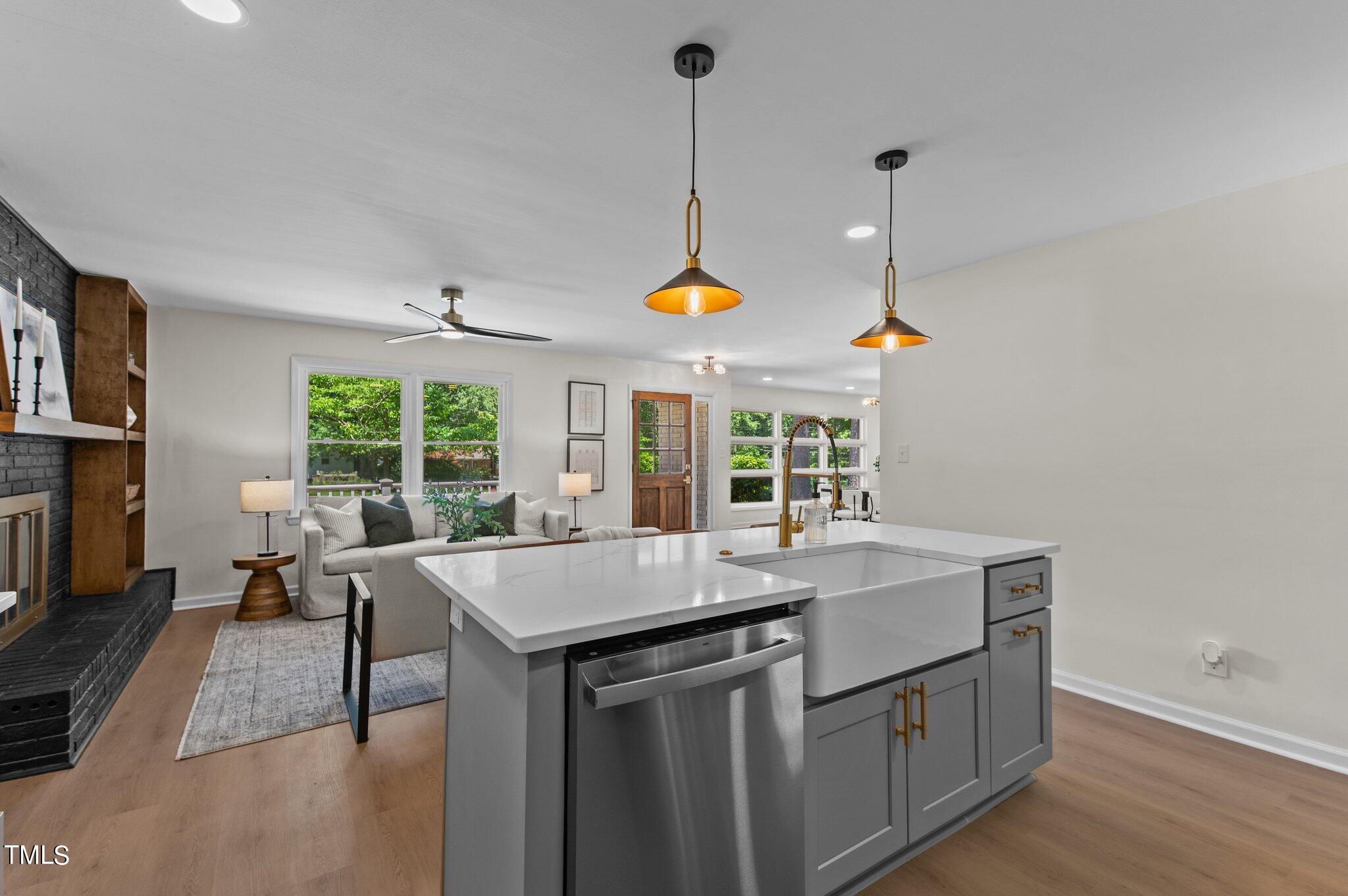 405 Roxanne Drive Raleigh, NC 27603 - Photo 15 of 48 a dining hall with stainless steel appliances granite countertop a sink a window and chairs