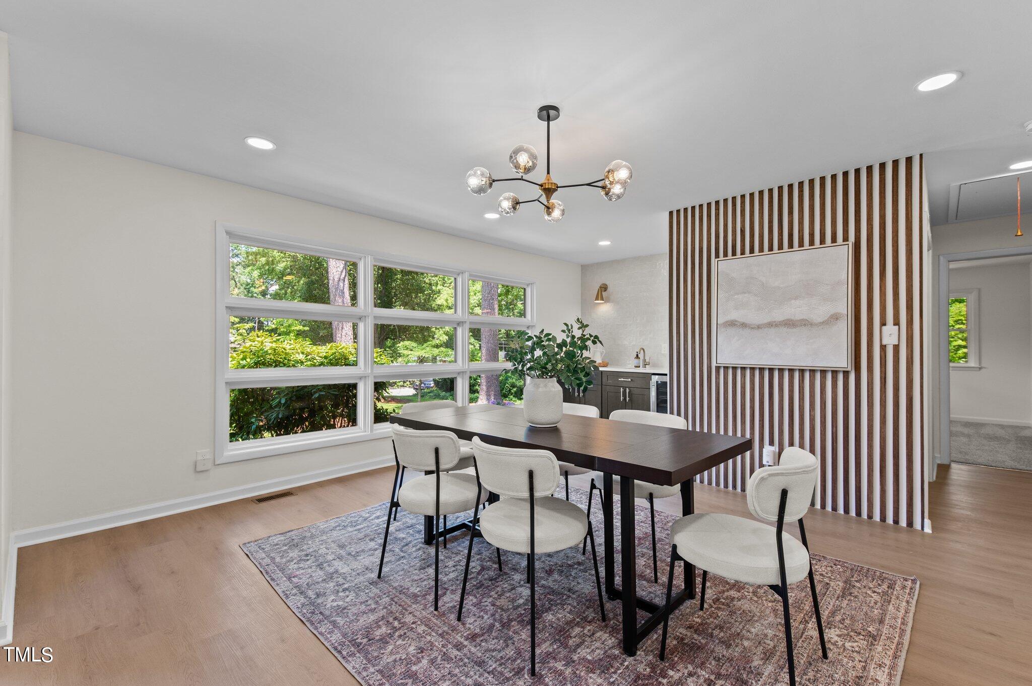 405 Roxanne Drive Raleigh, NC 27603 - Photo 18 of 48 a view of a dining room with furniture window and wooden floor