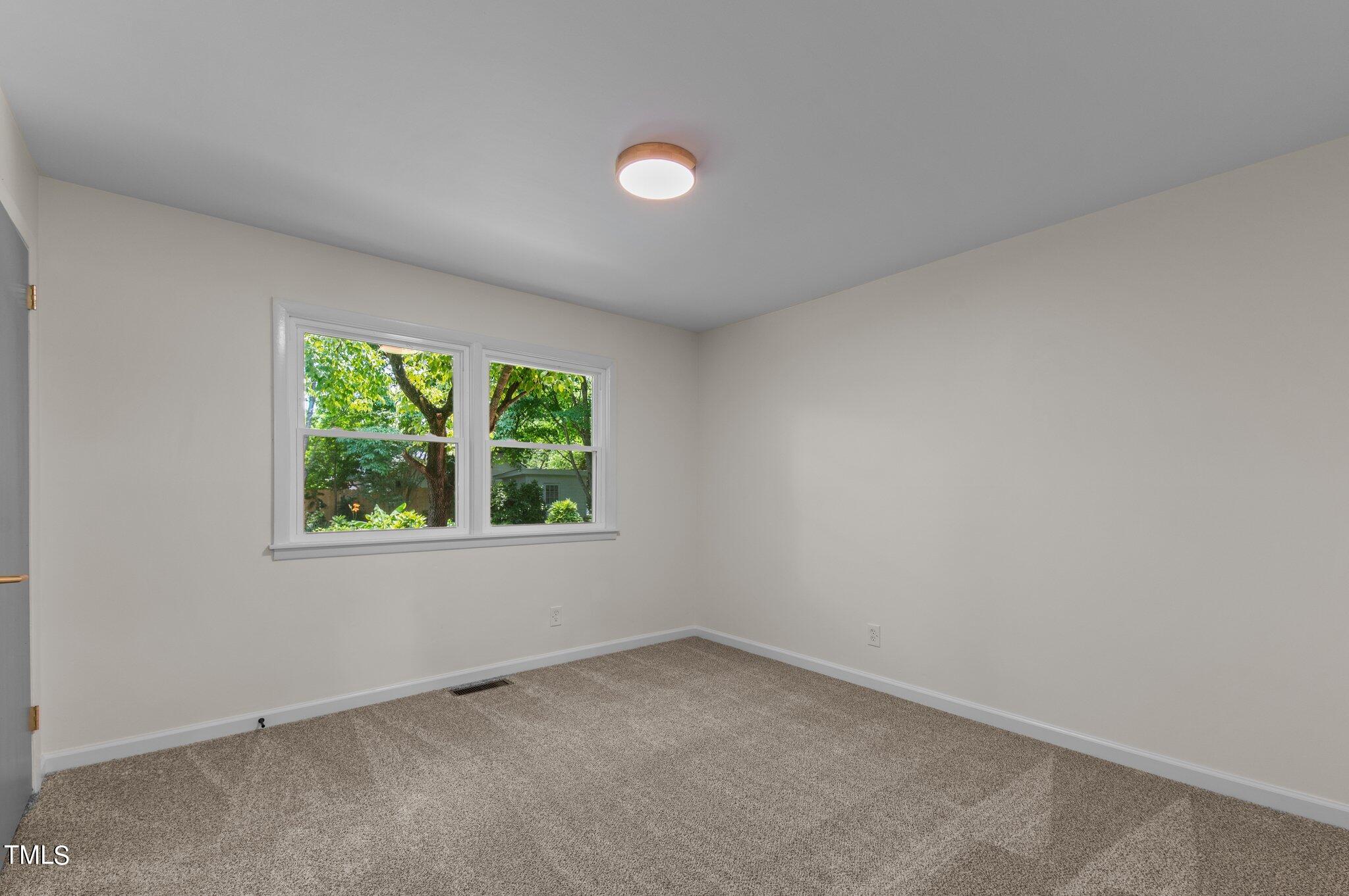 405 Roxanne Drive Raleigh, NC 27603 - Photo 25 of 48 an empty room with a window