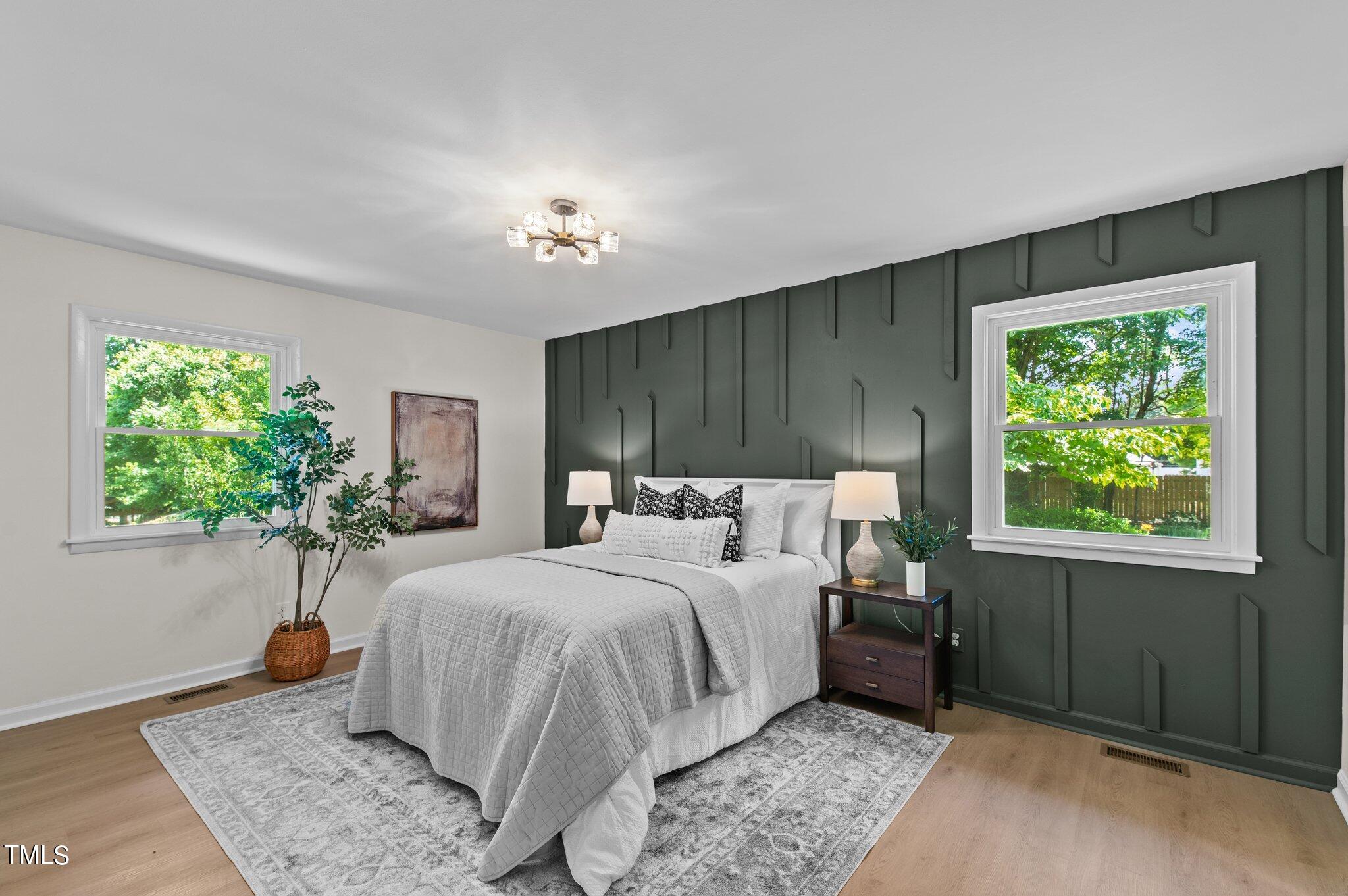 405 Roxanne Drive Raleigh, NC 27603 - Photo 29 of 48 a bedroom with a bed and a potted plant