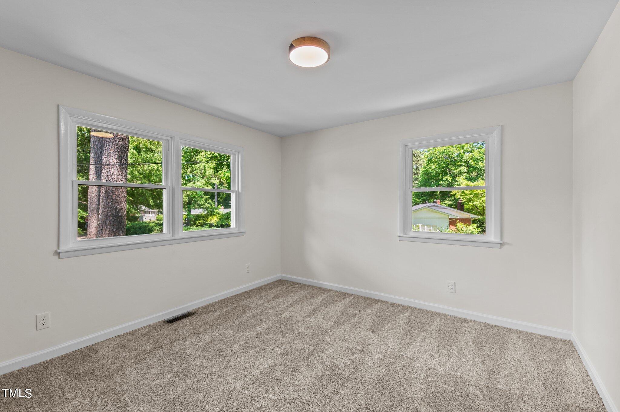 405 Roxanne Drive Raleigh, NC 27603 - Photo 35 of 48 an empty room with windows