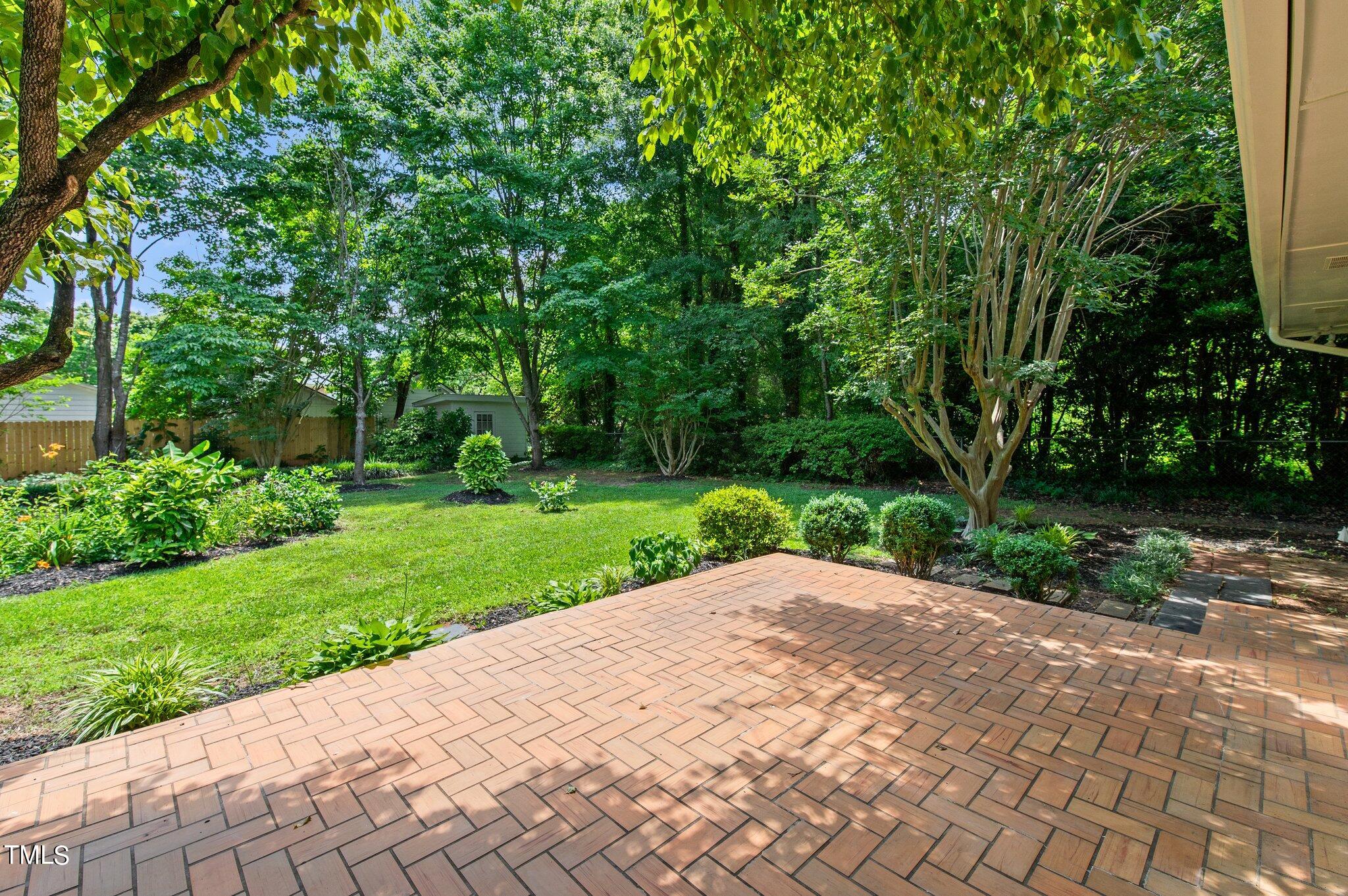405 Roxanne Drive Raleigh, NC 27603 - Photo 40 of 48 a view of a backyard with a garden