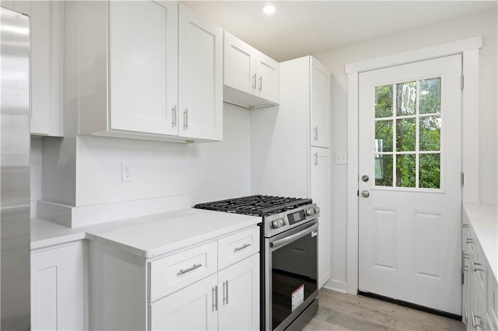 480 Songo Street Pittsburgh, PA 15227 - Photo 16 of 36 a kitchen with granite countertop white cabinets and white appliances