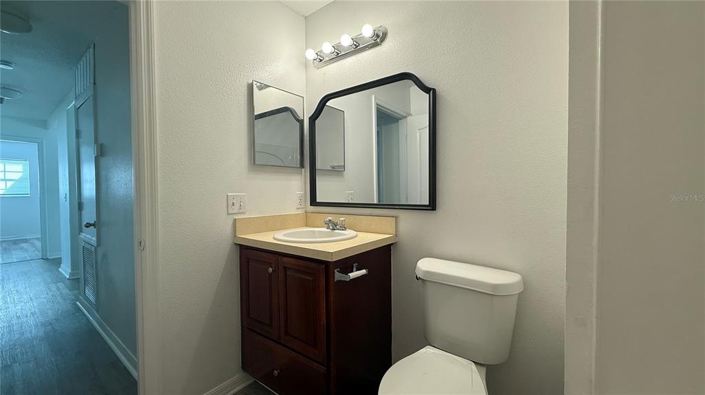 4484 Philadelphia Circle Kissimmee, FL 34746 - Photo 18 of 56 a bathroom with a toilet sink and mirror