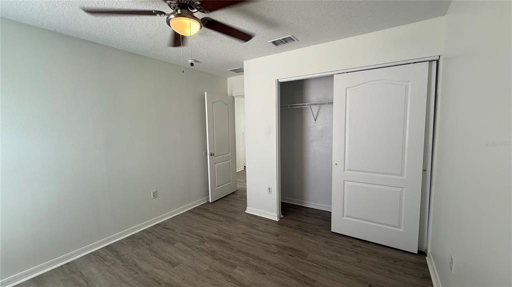 4484 Philadelphia Circle Kissimmee, FL 34746 - Photo 21 of 56 a view of empty room with wooden floor