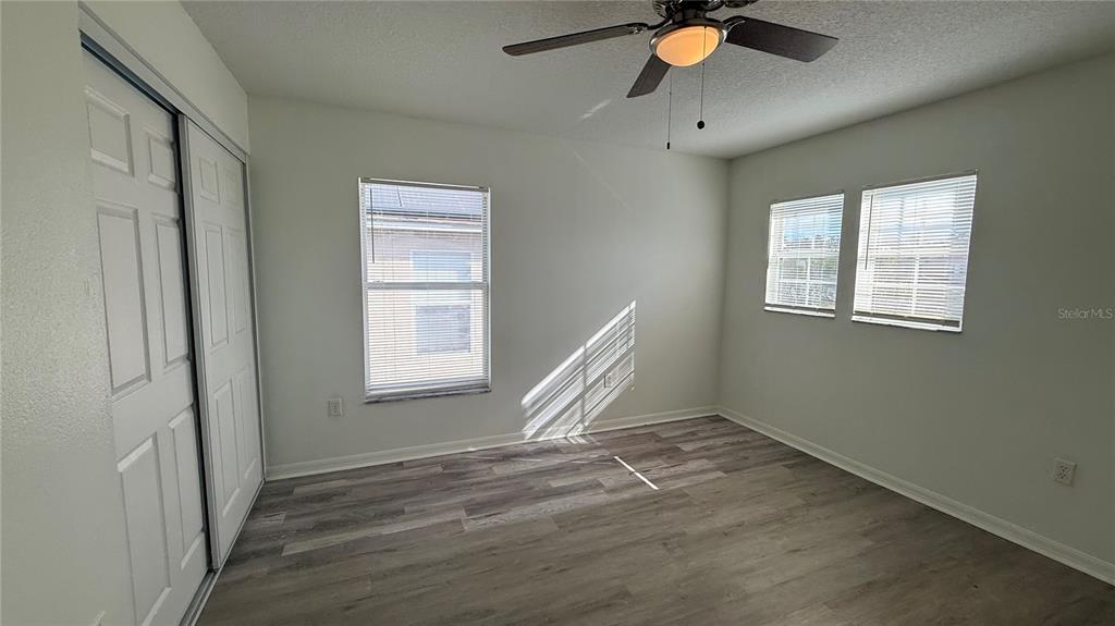 4484 Philadelphia Circle Kissimmee, FL 34746 - Photo 26 of 56 a view of an empty room with window and a ceiling fan
