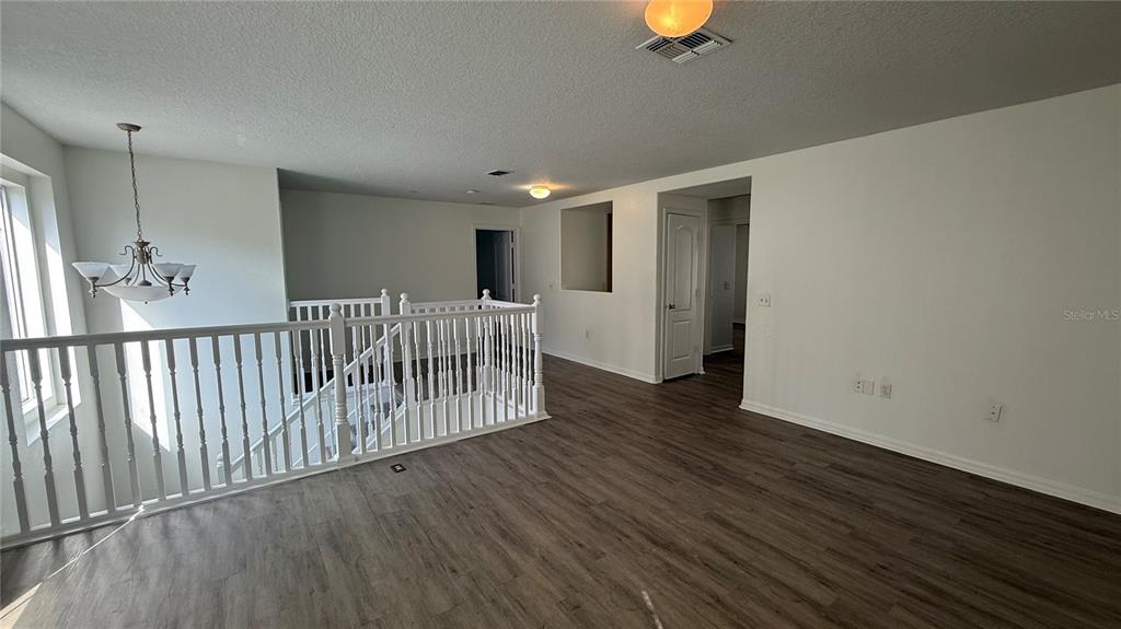 4484 Philadelphia Circle Kissimmee, FL 34746 - Photo 28 of 56 wooden floor in an empty room