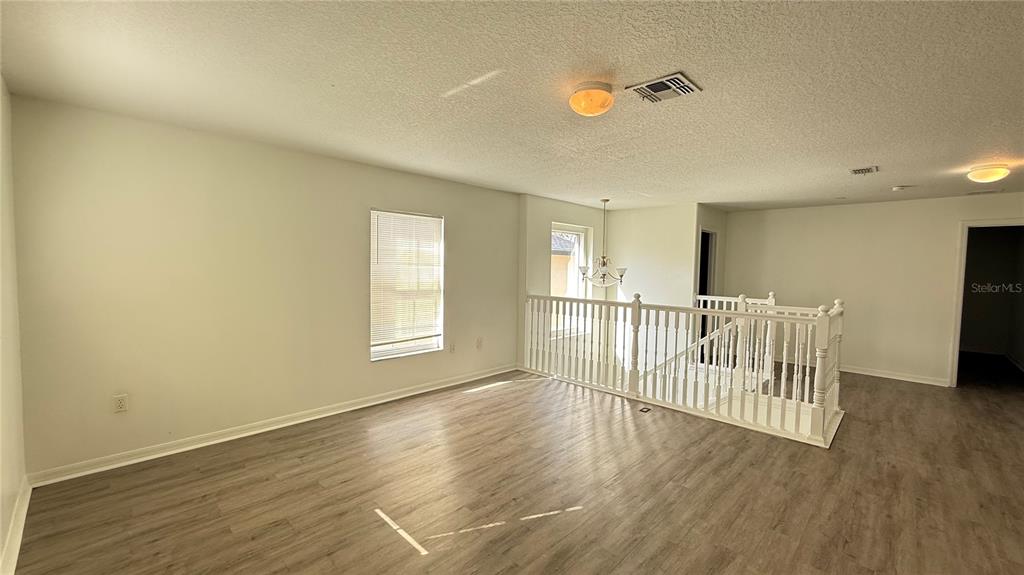 4484 Philadelphia Circle Kissimmee, FL 34746 - Photo 29 of 56 a view of a room with wooden floor and windows