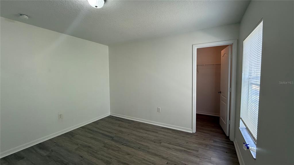 4484 Philadelphia Circle Kissimmee, FL 34746 - Photo 33 of 56 a view of an empty room with wooden floor and closet