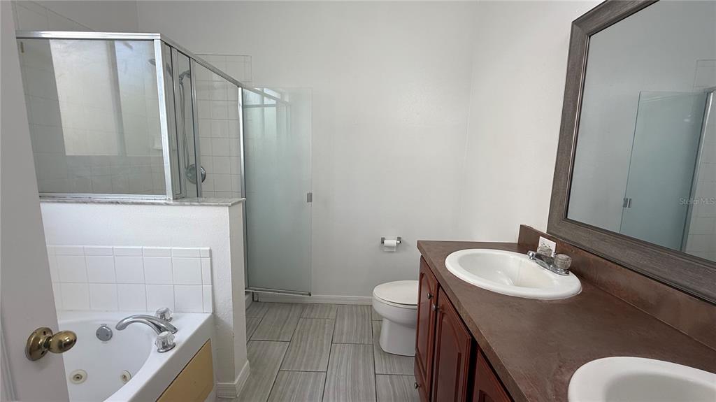 4484 Philadelphia Circle Kissimmee, FL 34746 - Photo 43 of 56 a bathroom with a sink toilet and shower