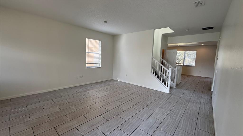 4484 Philadelphia Circle Kissimmee, FL 34746 - Photo 50 of 56 an empty room with wooden floor and a window