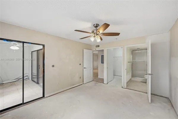 an empty room with a empty space and a ceiling fan
