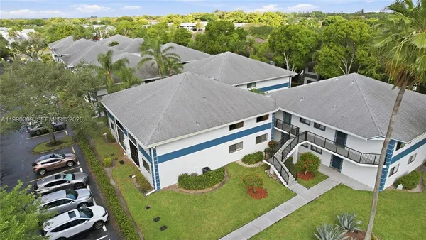 an aerial view of a house with garden space and street view