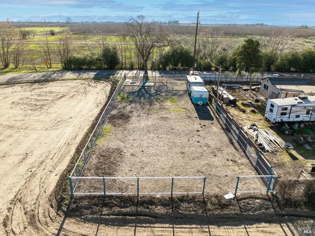 a view of a backyard with plants and a patio