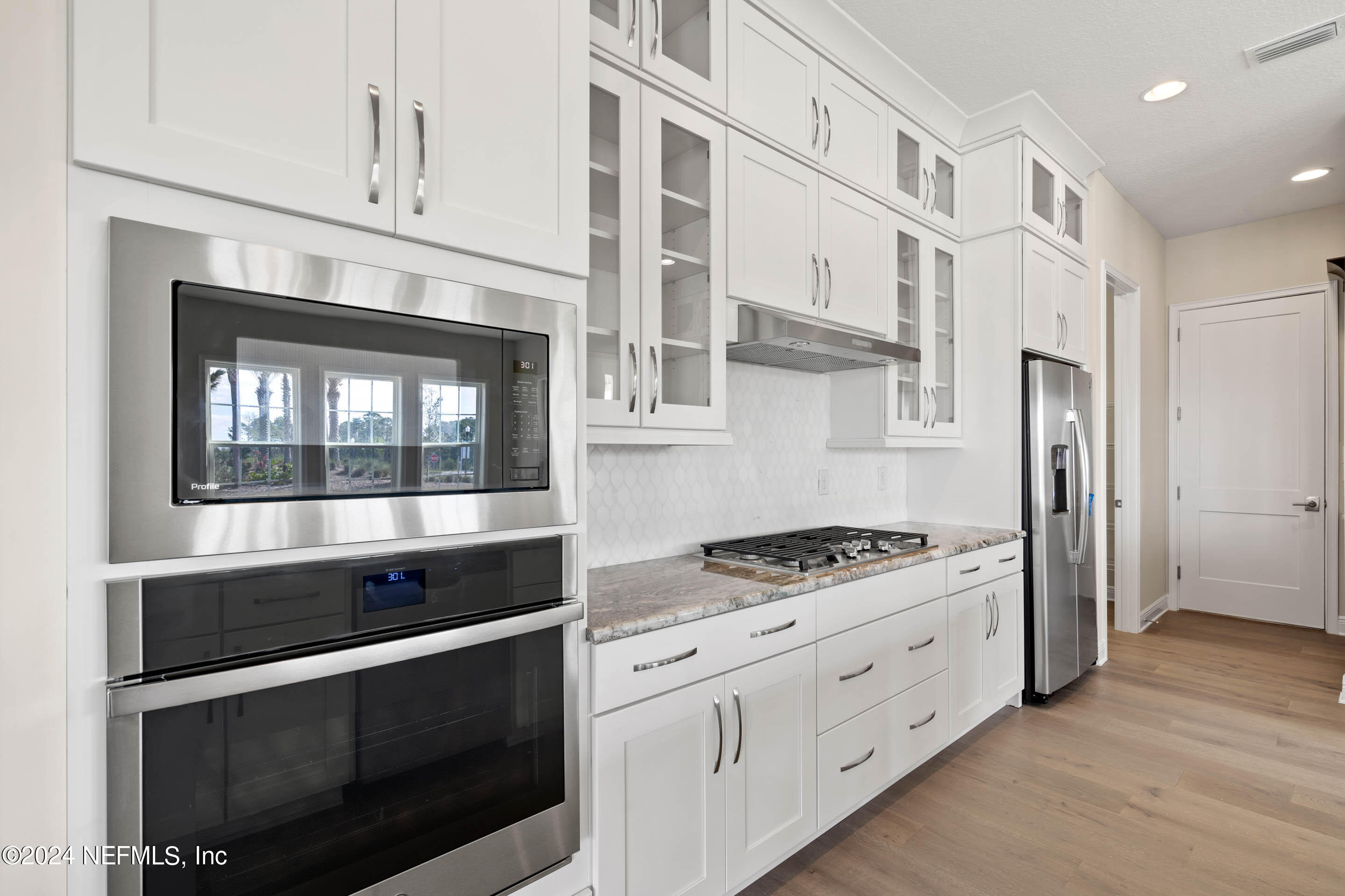 55 Rum Runner Way St. Johns, FL 32259 - Photo 11 of 55 a kitchen with stainless steel appliances white cabinets and a stove