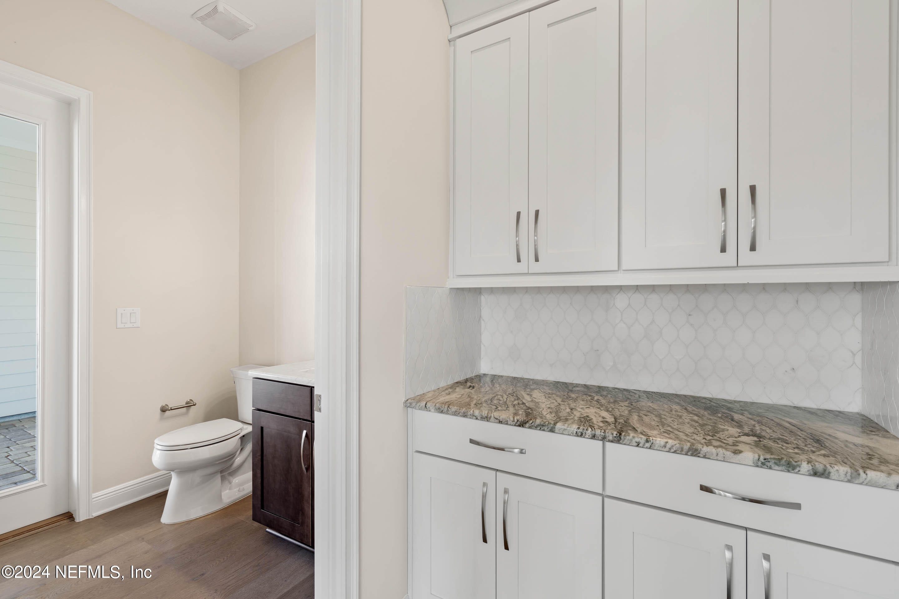 55 Rum Runner Way St. Johns, FL 32259 - Photo 14 of 55 a bathroom with a granite countertop toilet and a sink