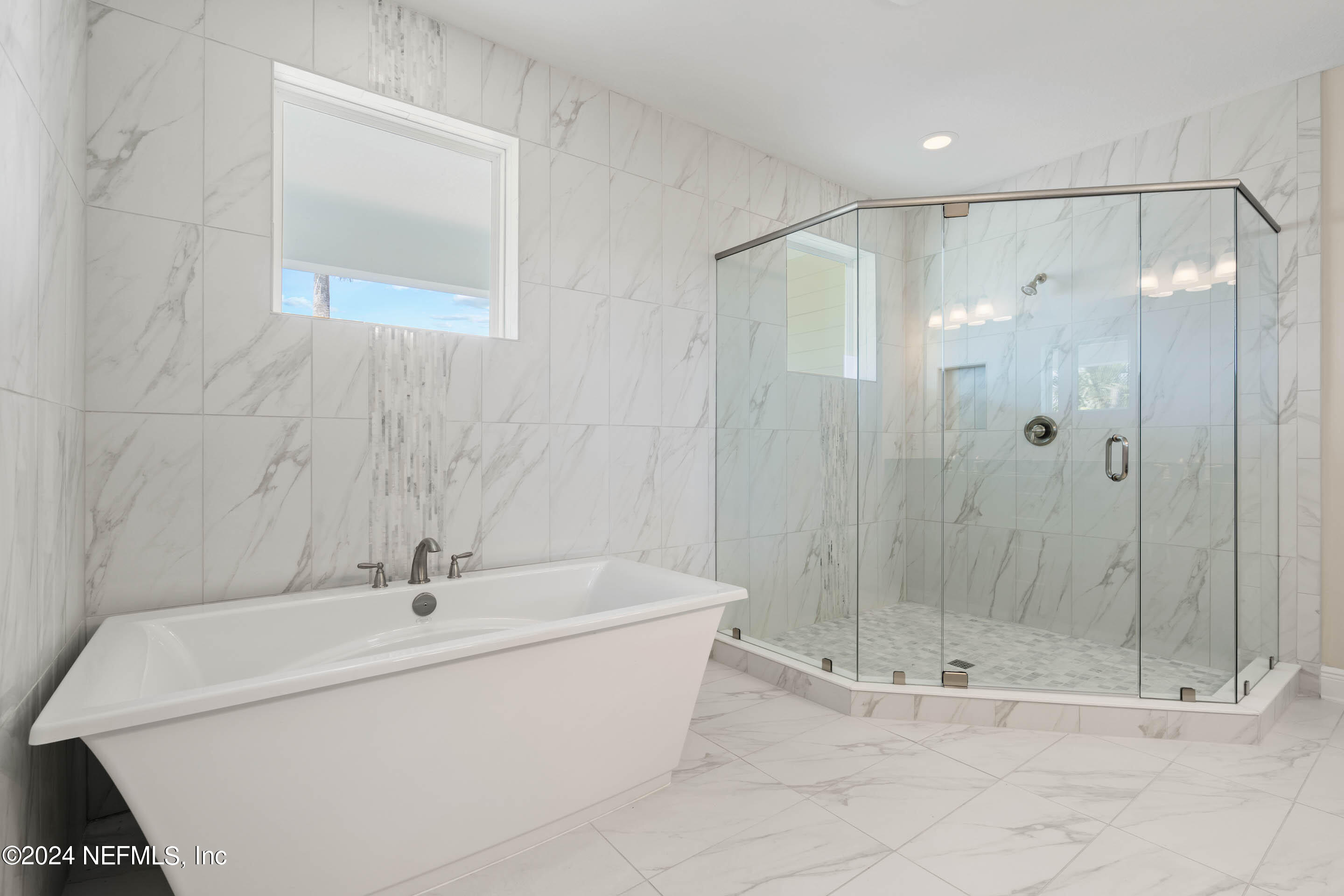 55 Rum Runner Way St. Johns, FL 32259 - Photo 24 of 55 a bathroom with a sink a mirror and a glass door shower