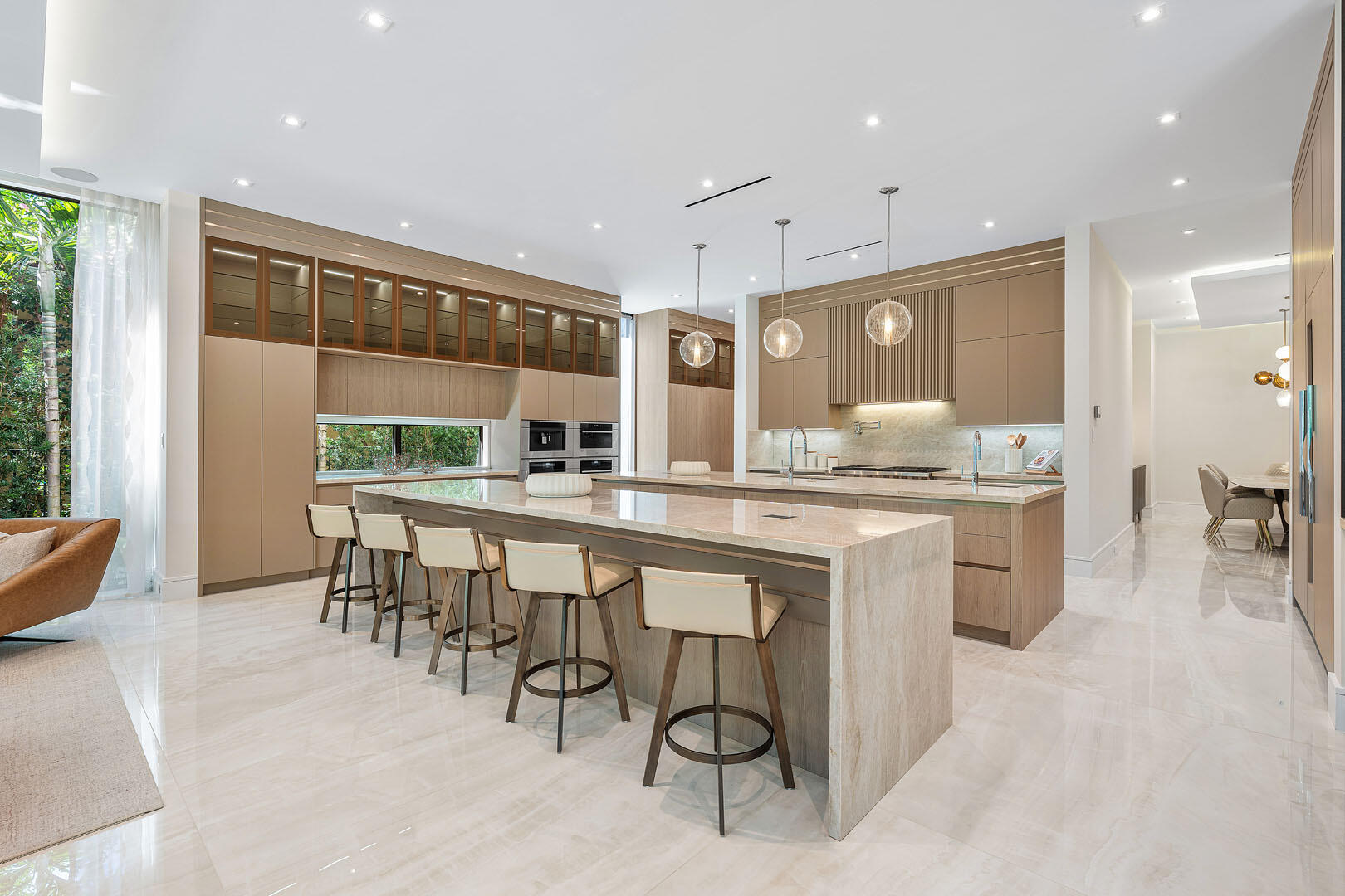 212 Alexander Palm Road Boca Raton, FL 33432 - Photo 15 of 75 a kitchen with kitchen island granite countertop wooden cabinets and counter space