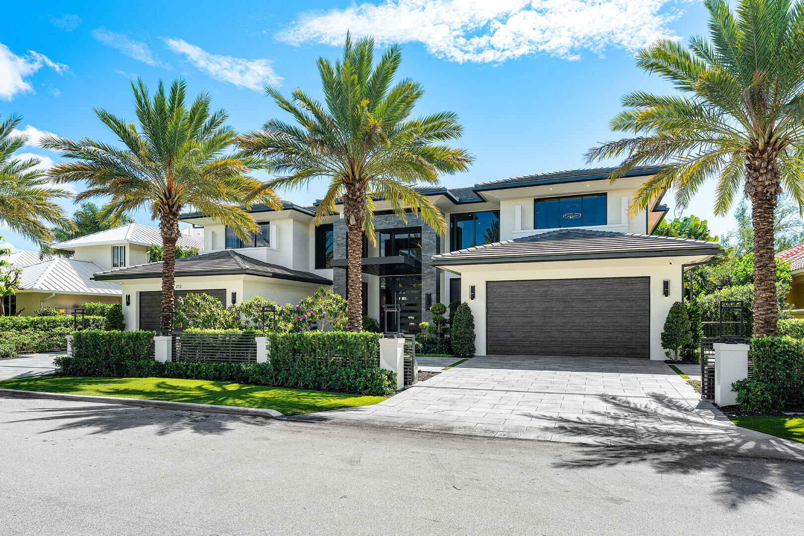 212 Alexander Palm Road Boca Raton, FL 33432 - Photo 4 of 75 a front view of a house with a yard and garage