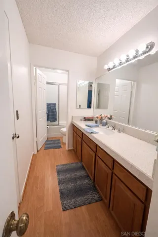 a spacious bathroom with a double vanity sink a mirror and a shower