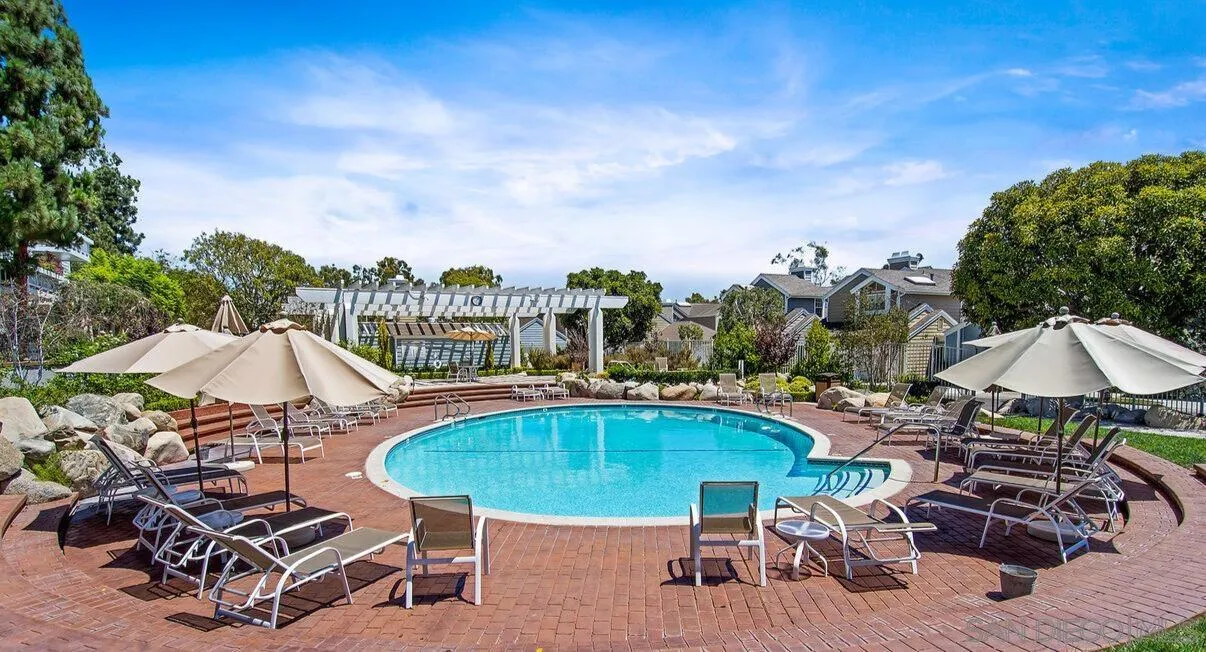 13078 Mindanao Way, Unit 101 Marina del Rey, CA 90292 - Photo 8 of 11 a view of a swimming pool with lawn chairs under an umbrella