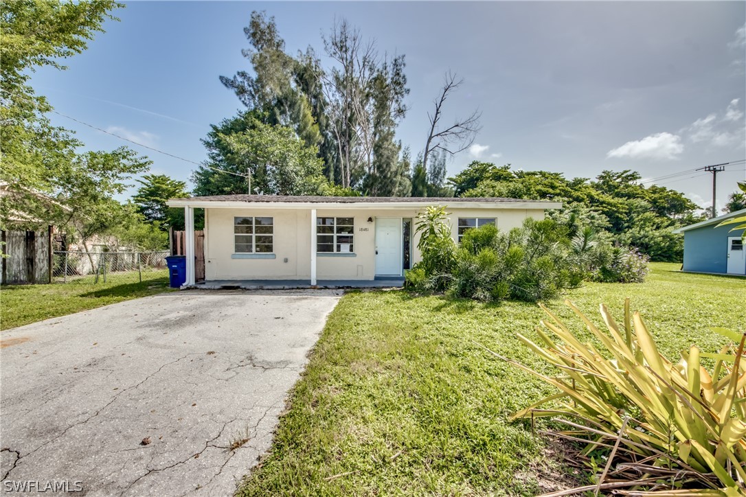 18481 Iris Road Fort Myers, FL 33967 - Photo 1 of 28 a view of a house with a yard and potted plants