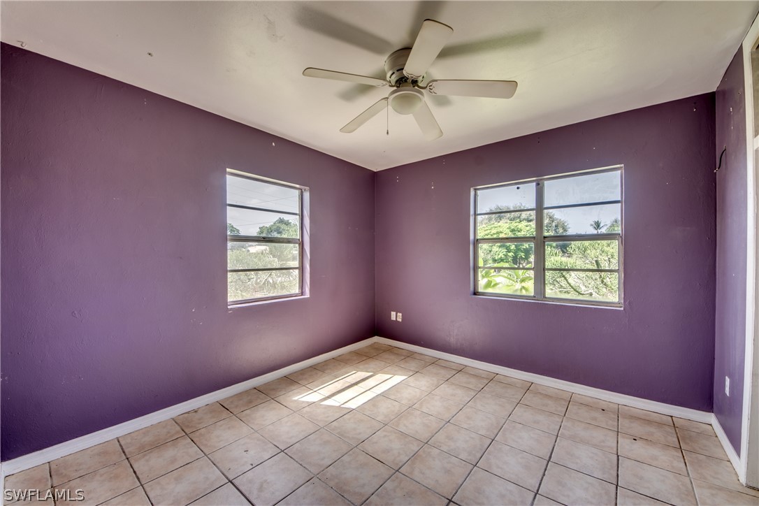 18481 Iris Road Fort Myers, FL 33967 - Photo 20 of 28 an empty room with windows and fan