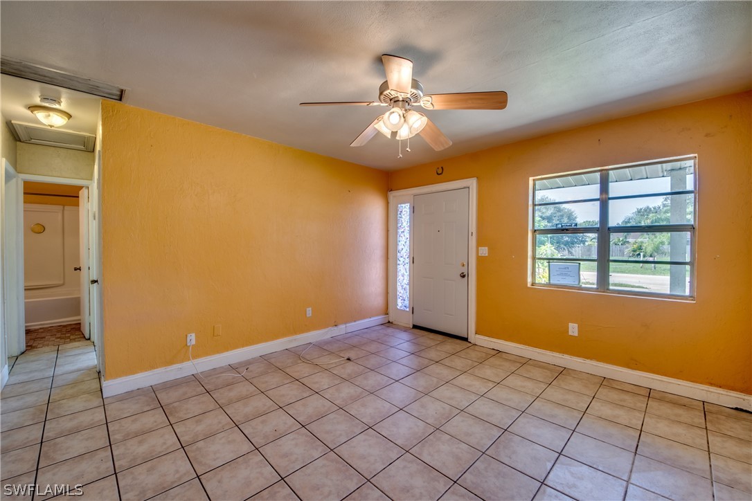 18481 Iris Road Fort Myers, FL 33967 - Photo 3 of 28 a view of an empty room with window and chandelier fan