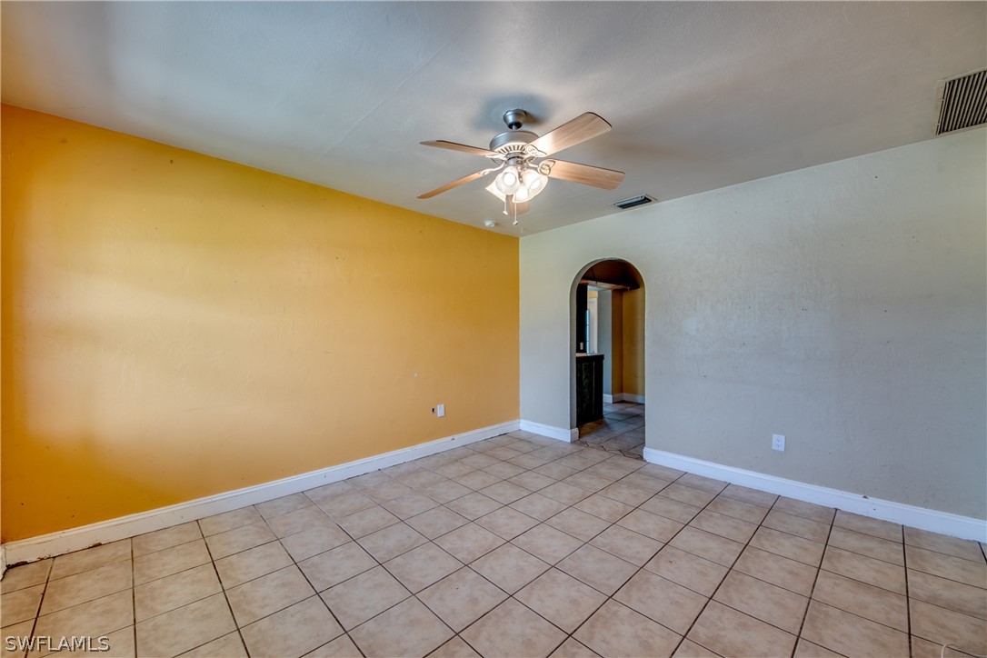 18481 Iris Road Fort Myers, FL 33967 - Photo 6 of 28 a view of an empty room with window and chandelier fan