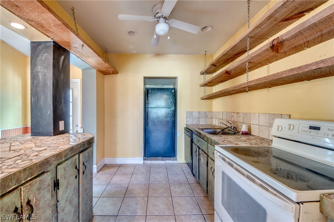 18481 Iris Road Fort Myers, FL 33967 - Photo 7 of 28 a kitchen with a stove and a sink