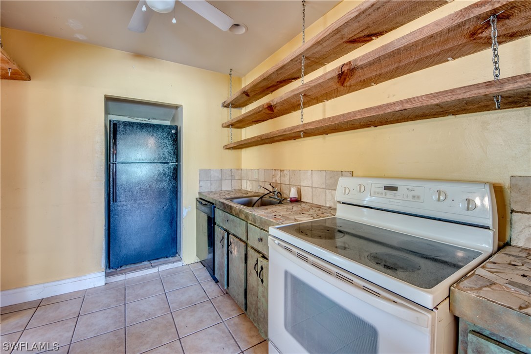 18481 Iris Road Fort Myers, FL 33967 - Photo 8 of 28 a stove top oven sitting inside of a kitchen