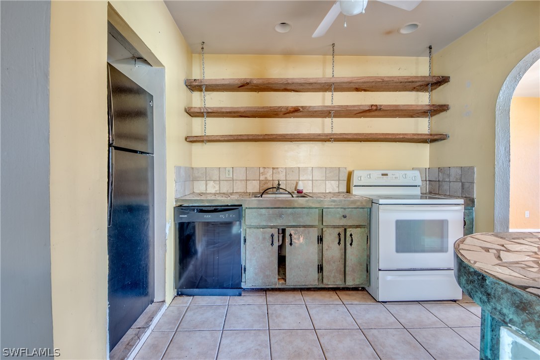 18481 Iris Road Fort Myers, FL 33967 - Photo 10 of 28 a kitchen with a stove and a refrigerator