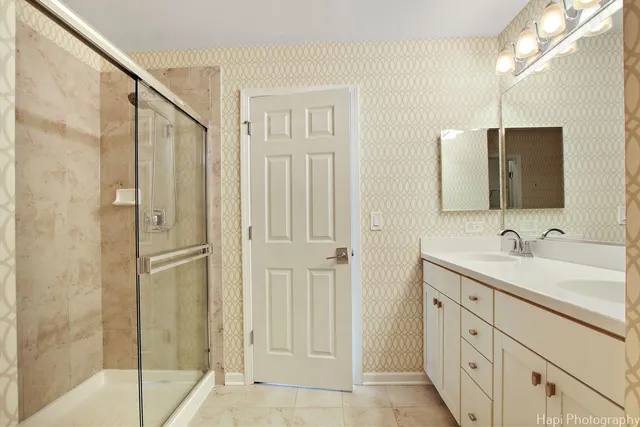 a bathroom with a double vanity sink and mirror