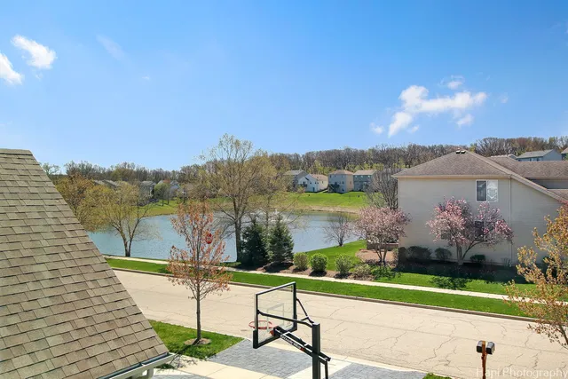 a view of a lake with a table and chairs