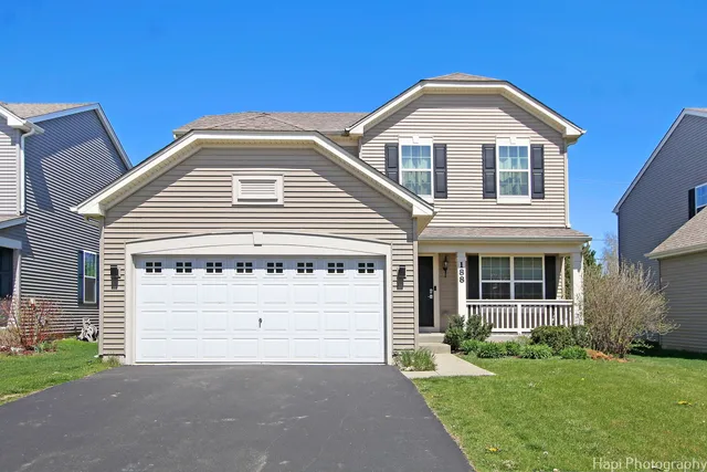 a front view of a house with a yard and garage